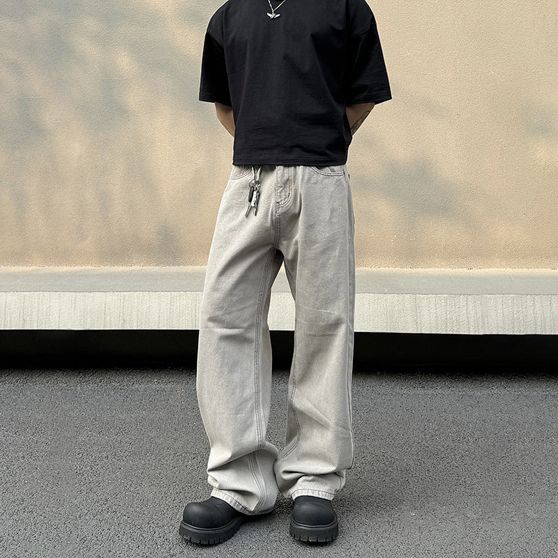 Jeans larghi uomo grigi, taglio confortevole a vita media, perfetti per outfit casual e moderni.