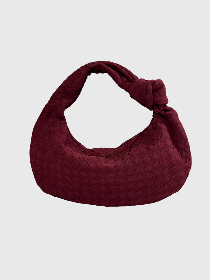 Elegante borsa da donna in suede intrecciato con nodo, accessorio versatile.