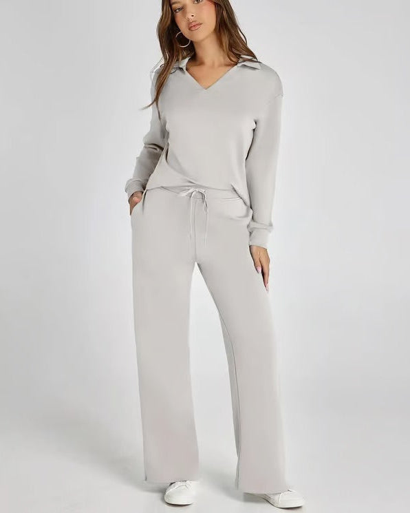 Set moda donna: felpa con scollo a V e pantaloni larghi, perfetti per look quotidiano comodo.