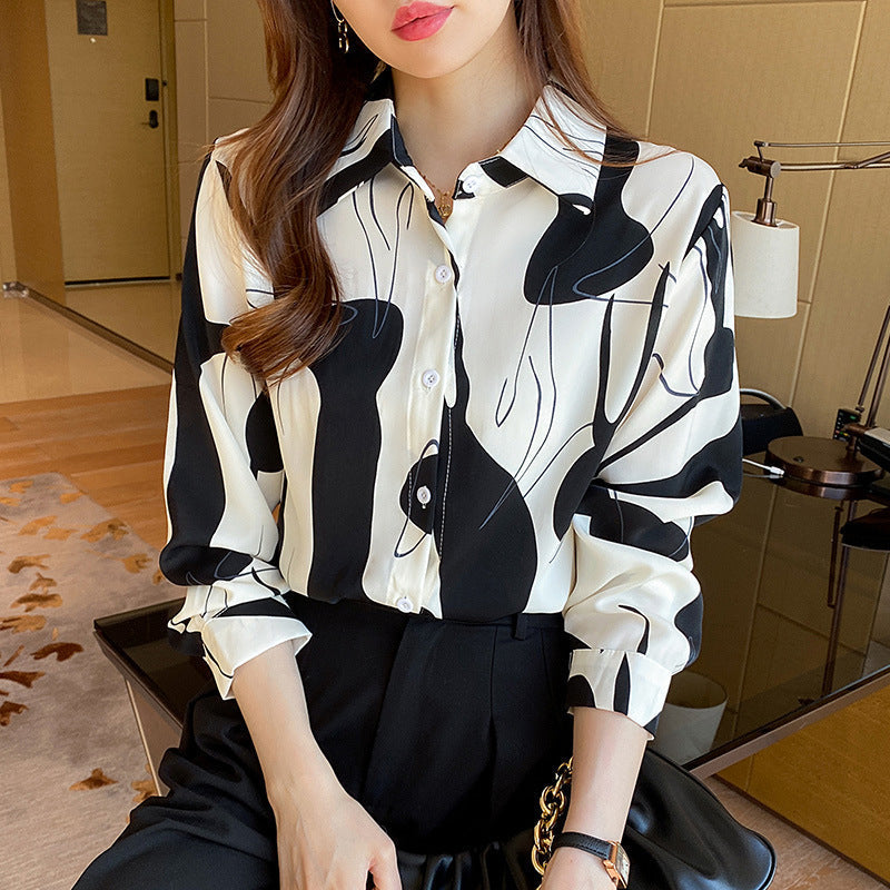 Camicia ampia da donna con stampa geometrica, maniche lunghe, ideale per outfit autunnali eleganti e casual.