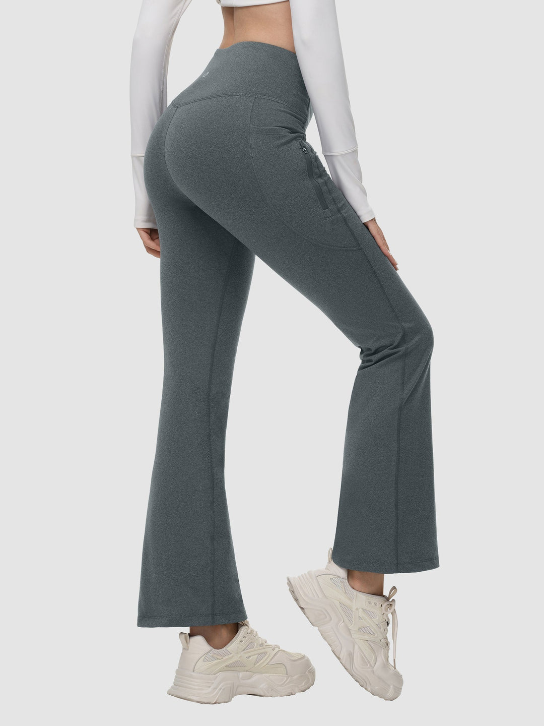 Pantaloni invernali sportivi donna, a vita alta, svasati, termici, con tasche laterali.