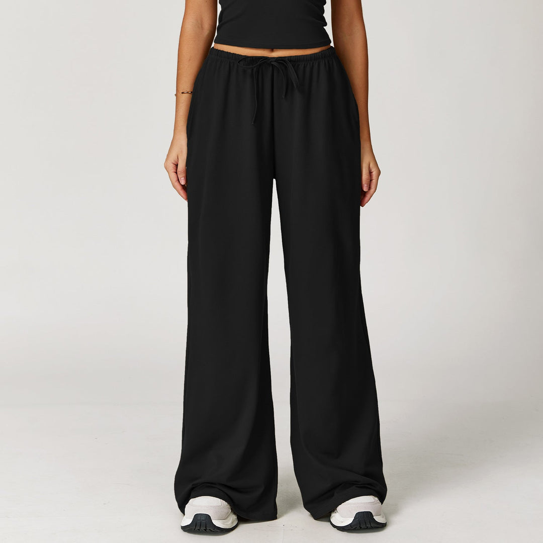 Pantaloni larghi donna vita alta con elegante dettaglio pendente. Perfetti per un look casual-sportivo e alla moda.