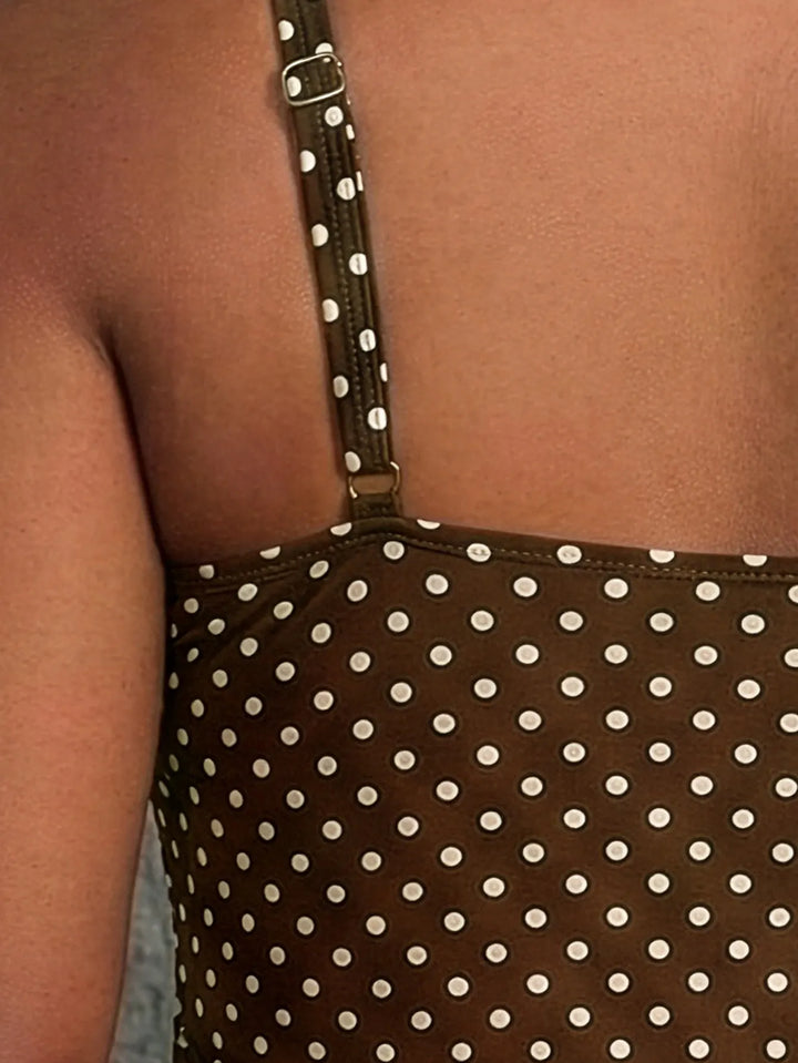 Costume intero donna per spiaggia e piscina, con fantasie palme e trasparenti inserti in rete.