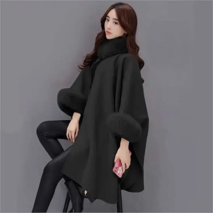Capospalla donna invernale versatile, mantella nera con raffinato bordo in ecopelliccia per outfit serali.