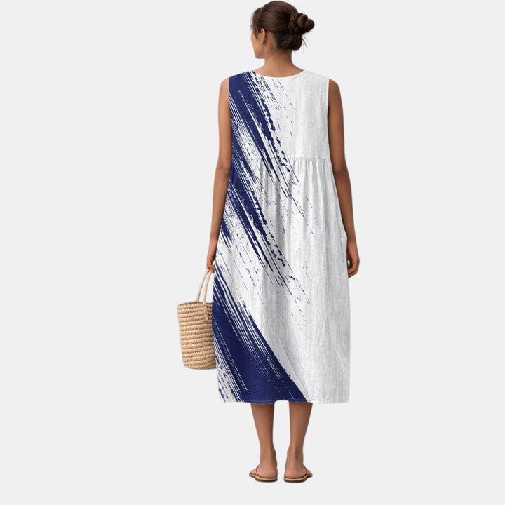 Abito donna midi senza maniche blu con elegante stampa astratta, ideale per look estivi chic o casual.