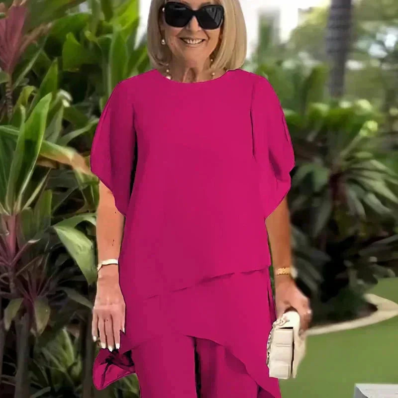 Set donna elegante: top drappeggiato e pantaloni palazzo a vestibilità fluida, moda formale e raffinata.