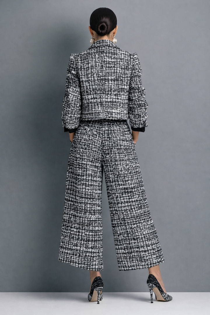Completo donna in tweed elegante. Giacca corta e pantaloni larghi per un outfit chic. Perfetto per la moda femminile.