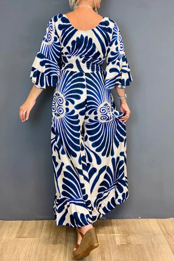 Tuta floreale da donna vintage, taglio ampio e maniche arricciate. Versatile per un look elegante o casual-chic.