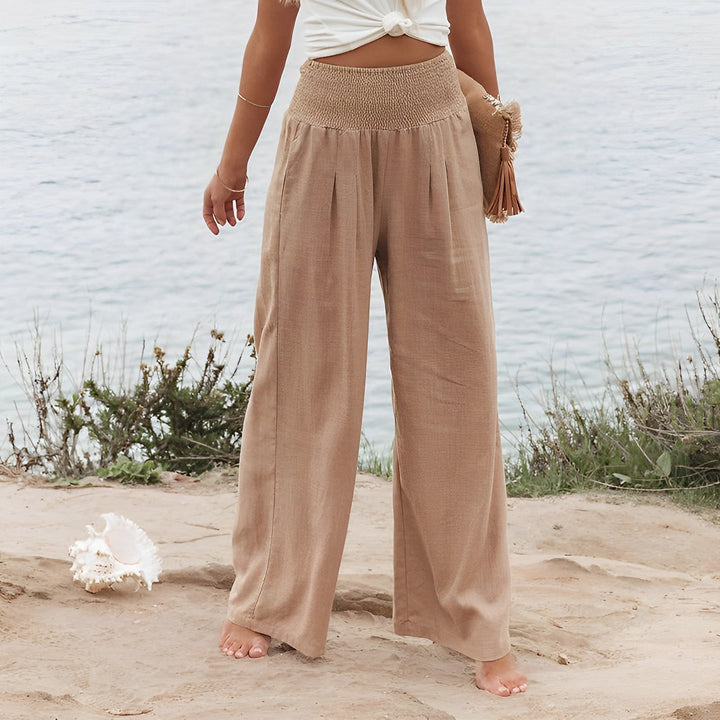Pantaloni fluidi e larghi donna, vita alta palazzo, perfetti per un look estivo casual e sofisticato.