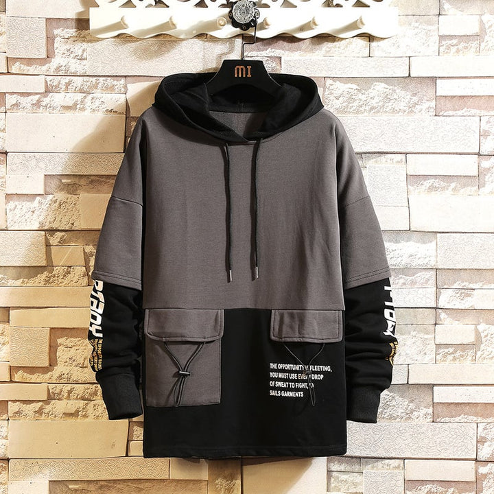 Pullover moderno da uomo con cappuccio e design a blocchi colore, ideale per un look invernale.