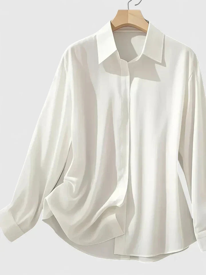 Camicia donna elegante con maniche lunghe, bottoni nascosti e orlo curvo, ideale per l'ufficio.