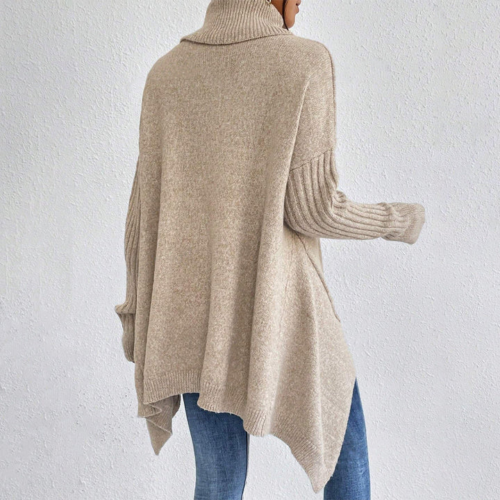 Abbigliamento donna moda: maglione dolcevita con orlo asimmetrico, perfetto per un look elegante.