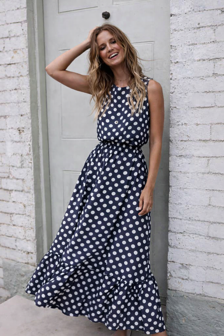 Abito da donna a pois, con scollo a V e linea svasata, stile vintage elegante.