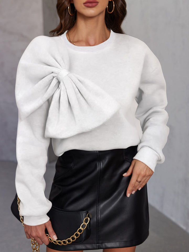 Pullover donna elegante in maglia morbida con fiocco. Maglione girocollo a maniche lunghe per un look confortevole e alla moda.