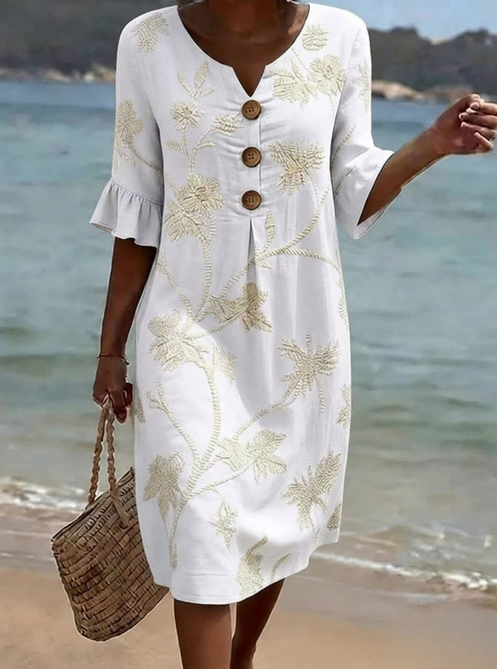 Elegante abito floreale in cotone per donna, con maniche 3/4, perfetto per la moda estiva casual.