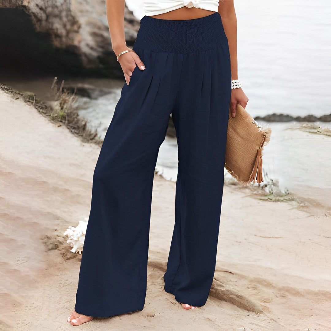 Pantaloni ampi e leggeri donna, vita alta, stile palazzo, ideali per giornate calde e serate estive.