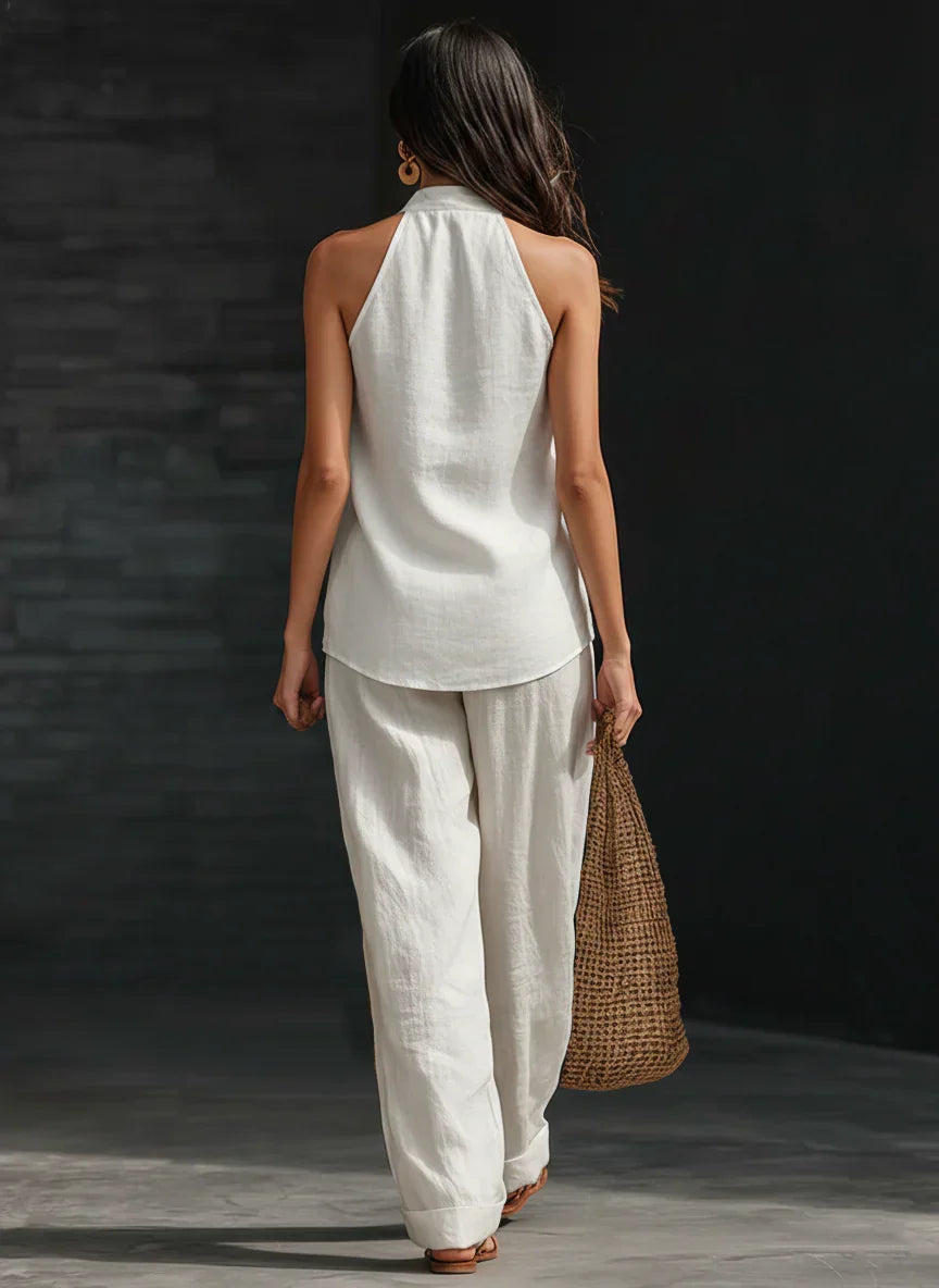 Top scollo a V e pantaloni a gamba larga in set coordinato donna. Vita alta, giromanica americana, look versatile.