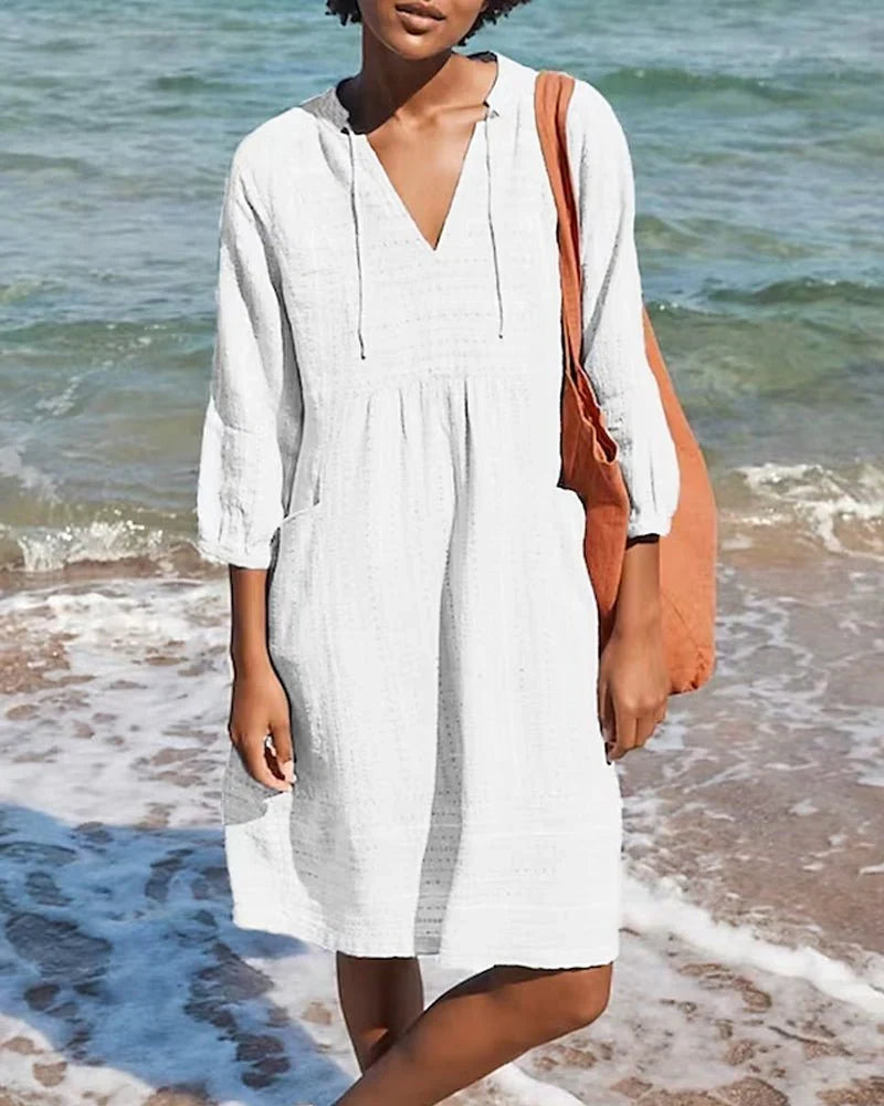 Abito tunica versatile da donna, con cappuccio, scollo a V e maniche arrotolabili. Per un look chic e rilassato.