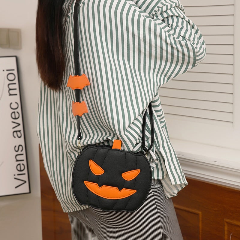 Accessorio donna moda Halloween: borsa a tracolla con design zucca Jack-O-Lantern e pipistrelli.