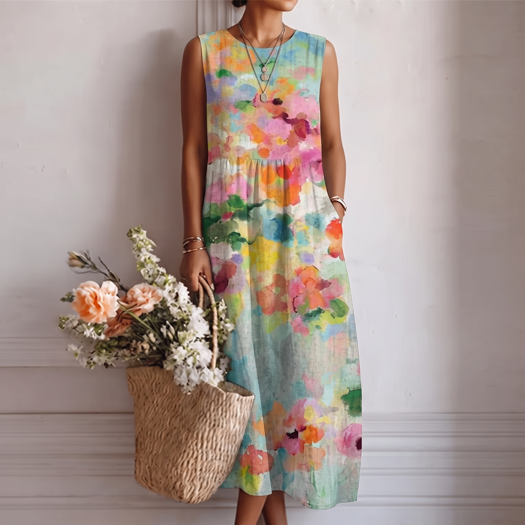 Abito midi smanicato donna con vivace stampa acquerello, perfetto per primavera ed estate. Vestito fluido e colorato.