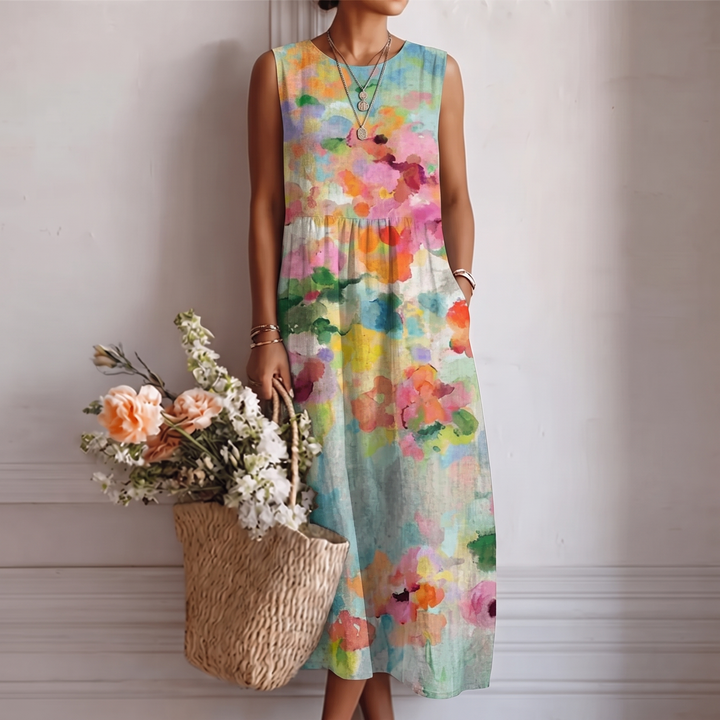 Abito midi smanicato donna con vivace stampa acquerello, perfetto per primavera ed estate. Vestito fluido e colorato.