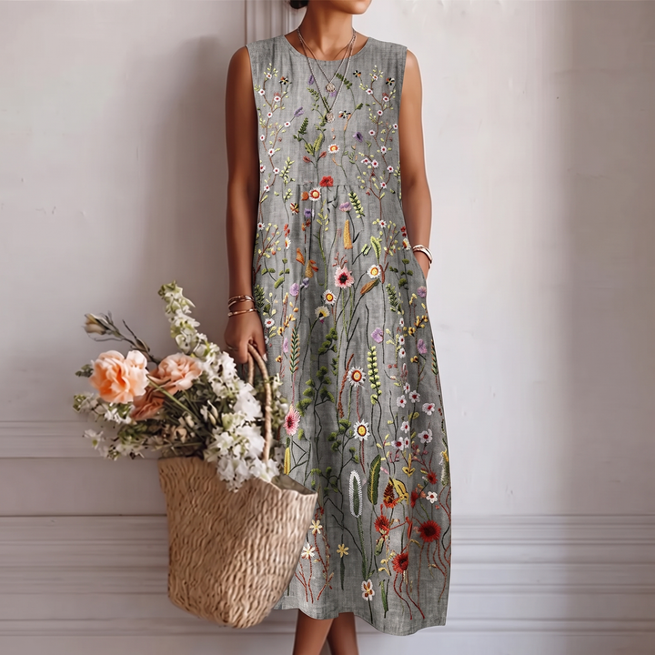Abito midi donna elegante senza maniche con ricamo floreale, stile fluido, perfetto per primavera/estate.