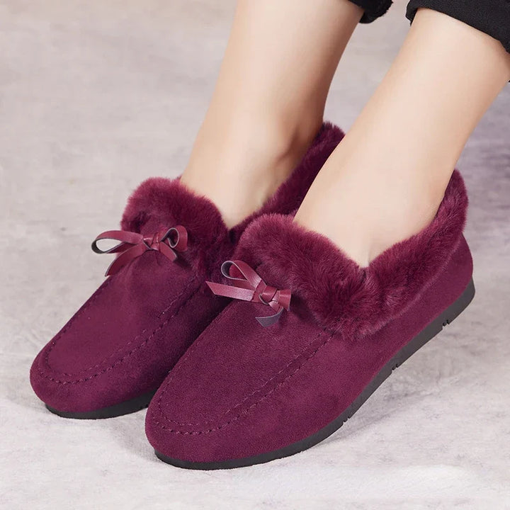 Donna che cammina con scarpe invernali grigie, godendo del comfort e del calore nelle giornate fredde.