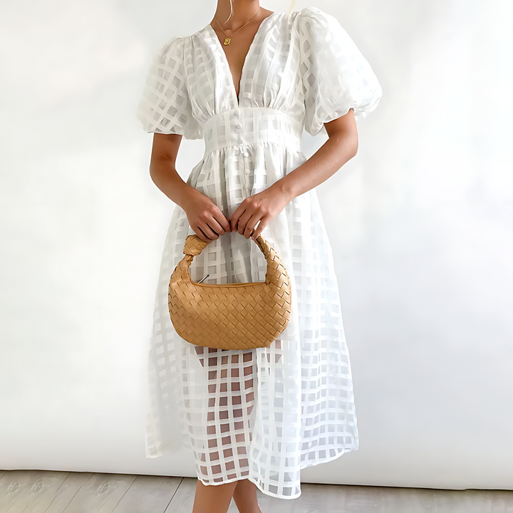 Abito midi donna elegante con maniche a sbuffo e fantasia geometrica, perfetto per un look sofisticato.