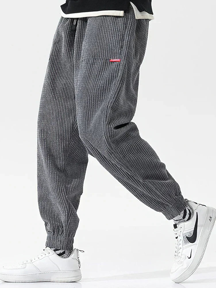 Texture dei pantaloni uomo in velluto a coste. Morbidi, comodi e alla moda, ideali per ogni occasione casual.