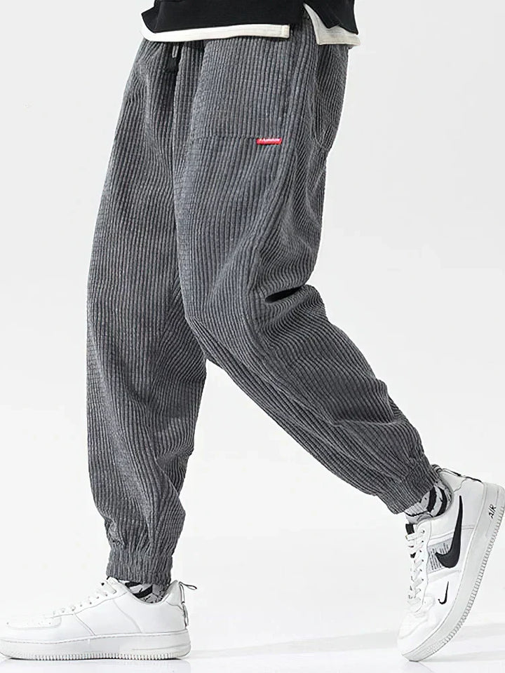 Texture dei pantaloni uomo in velluto a coste. Morbidi, comodi e alla moda, ideali per ogni occasione casual.