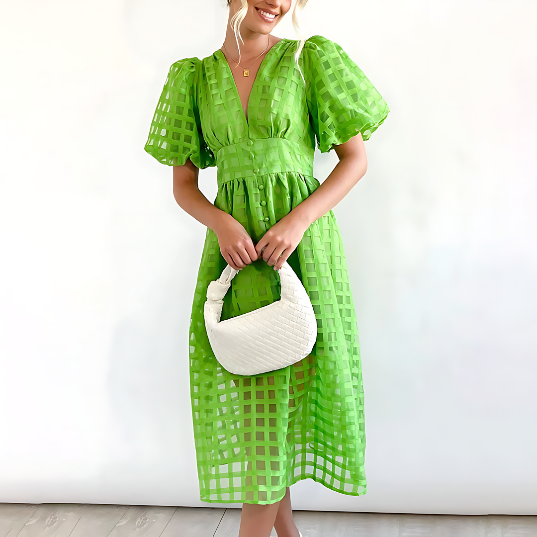 Chic abito midi donna con vivace fantasia geometrica e maniche a sbuffo, ideale per eventi o look quotidiani.