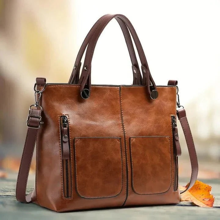 Borsa donna strutturata con doppi manici e tracolla rimovibile, un accessorio elegante e versatile per ogni outfit.