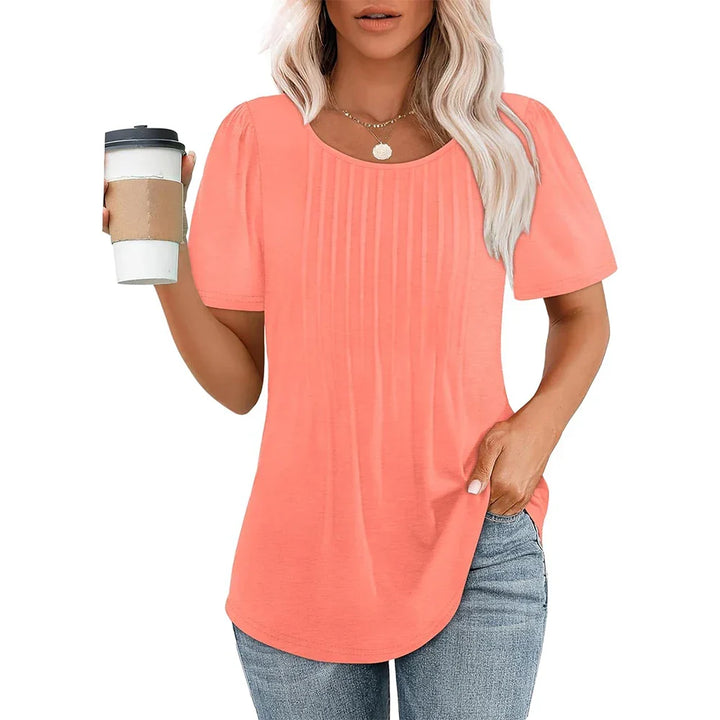 Blusa donna plissettata con manica corta e scollo tondo. Stile versatile, perfetta per moda estiva elegante.