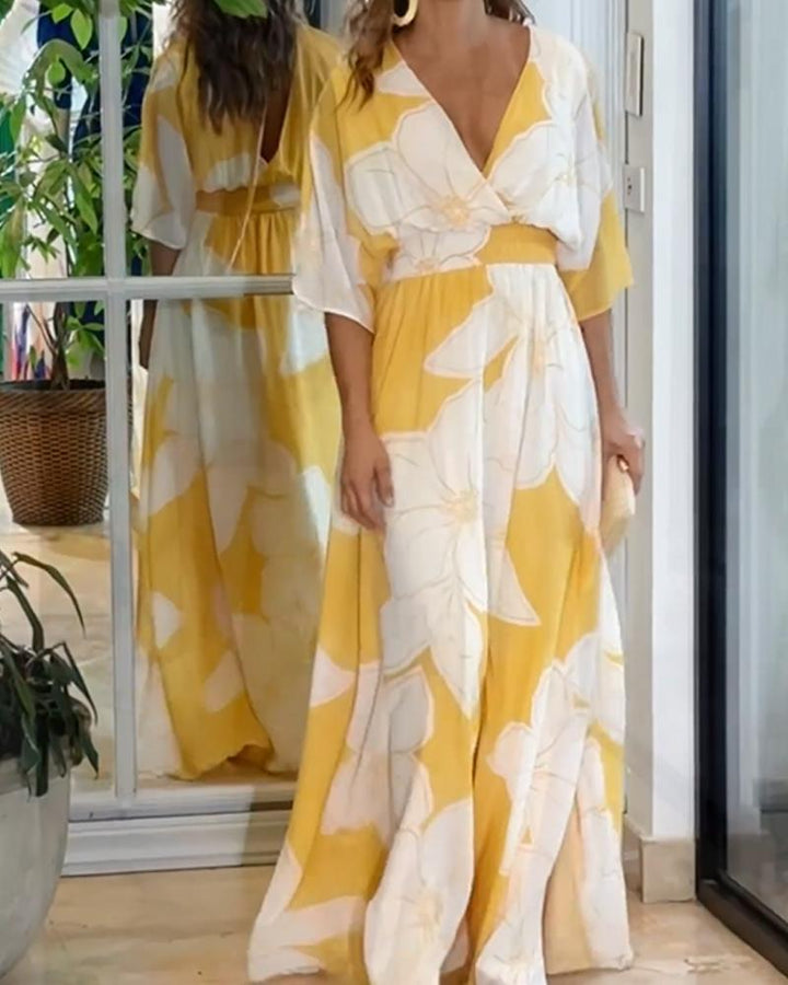Abito midi donna giallo floreale con scollo a V, gonna fluida. Perfetto per l'estate, stile elegante e confortevole.