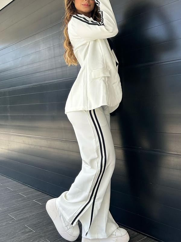 Elegante completo blazer e pantaloni donna a righe, perfetto per look coordinati da ufficio o casual chic.