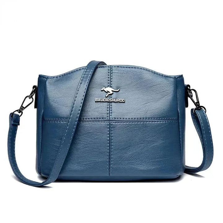 Borsa in pelle grigia da donna, spaziosa, stile classico, con tracolla removibile.