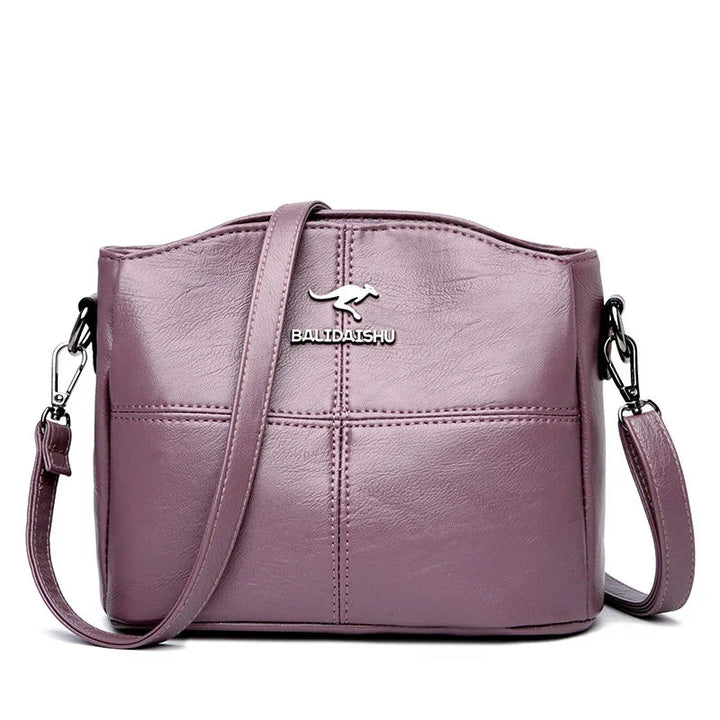 Borsa a mano in pelle blu scuro, versatile per lavoro e tempo libero.
