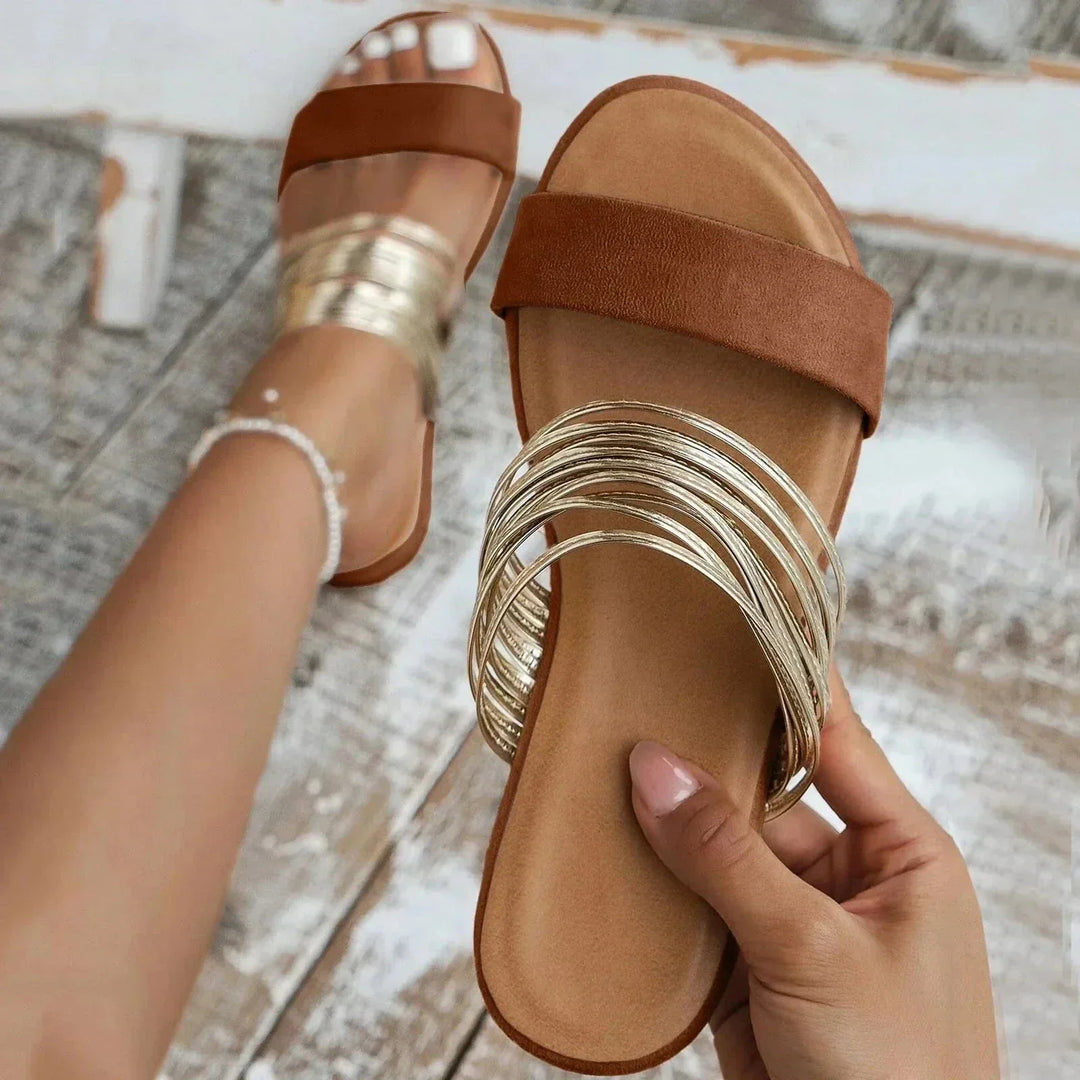 Sandali sliders ammortizzati con elegante doppia fascia e raffinato dettaglio metallico. Ideali per il comfort.