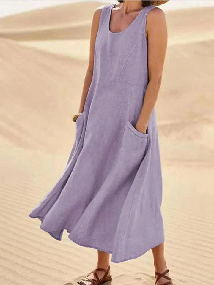 Moda donna: vestito lungo senza maniche, scollo rotondo. Abito estivo fluido con tasche, ideale per look casual.