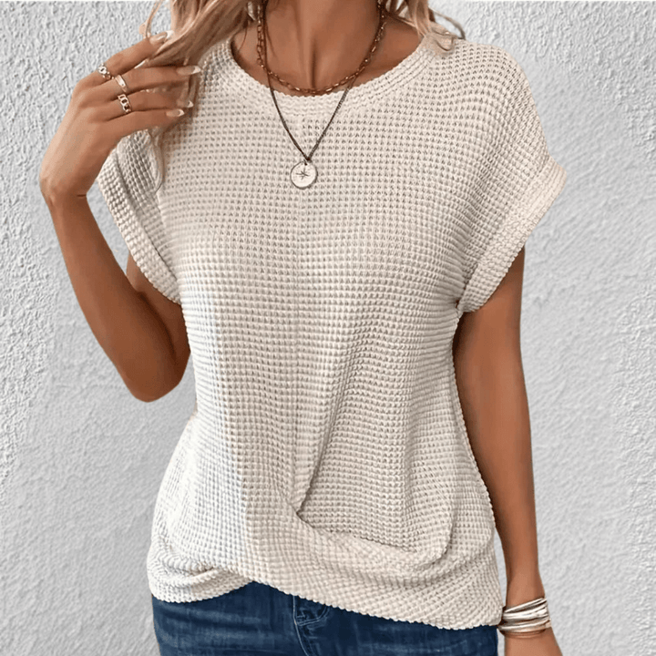 Top donna con scollo rotondo e trama distintiva. Design moderno ed elegante per ogni guardaroba.