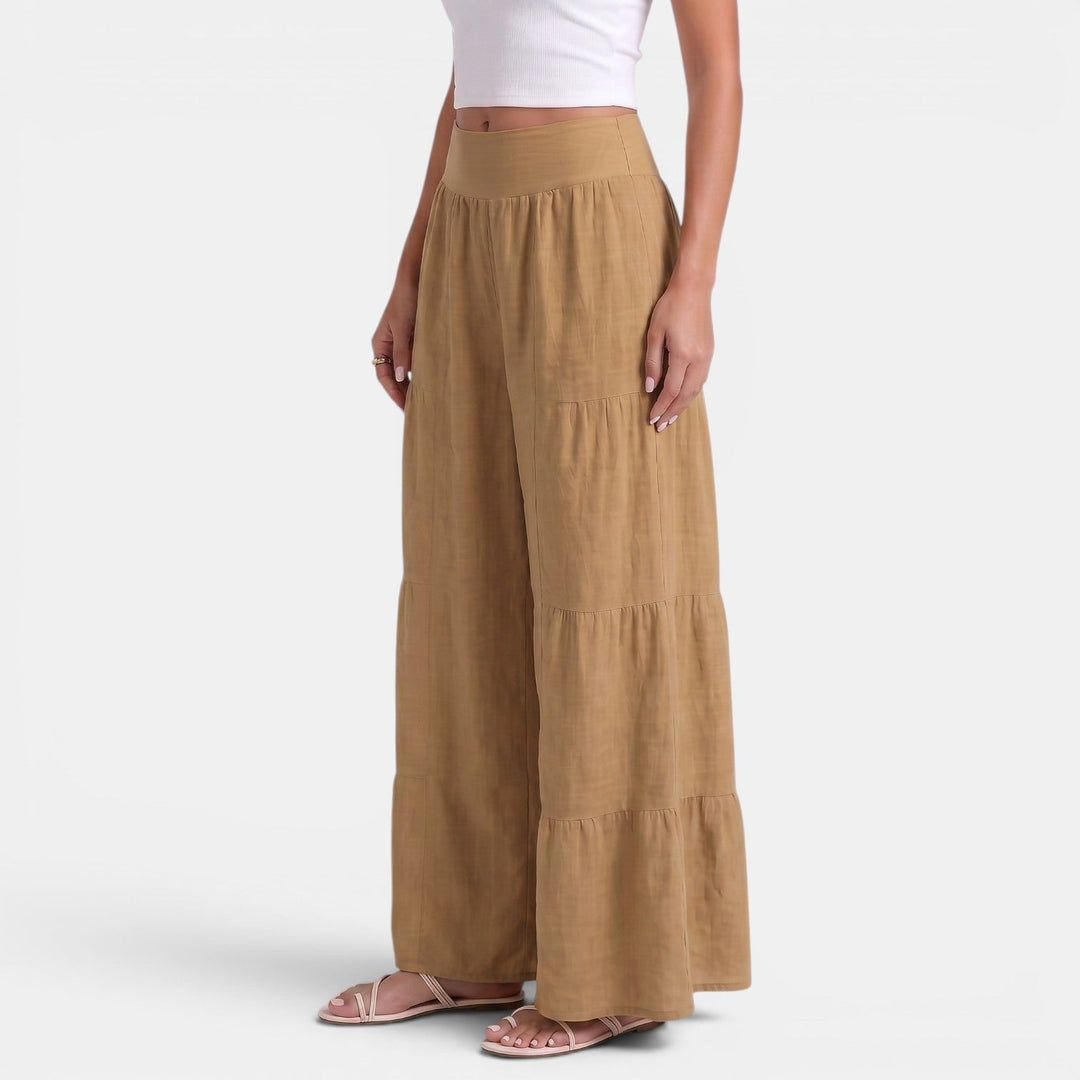 Pantaloni donna ampi in lino blu, fluidi al movimento, ideali per look estivi rilassati e confortevoli.