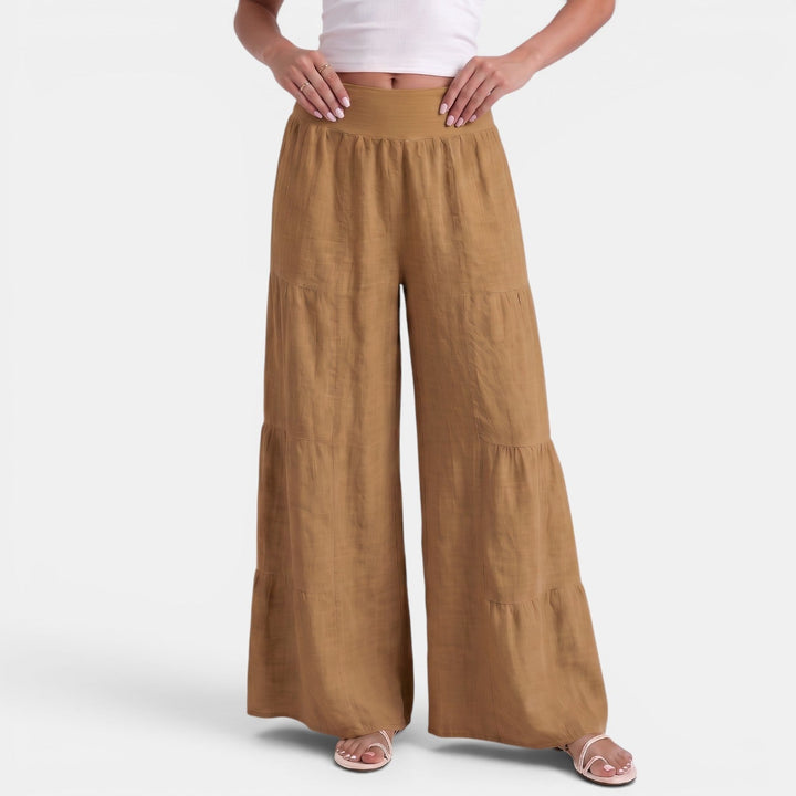 Pantaloni donna in lino fluido con elastico in vita sul retro, ampi e comodi per la moda estiva casual.