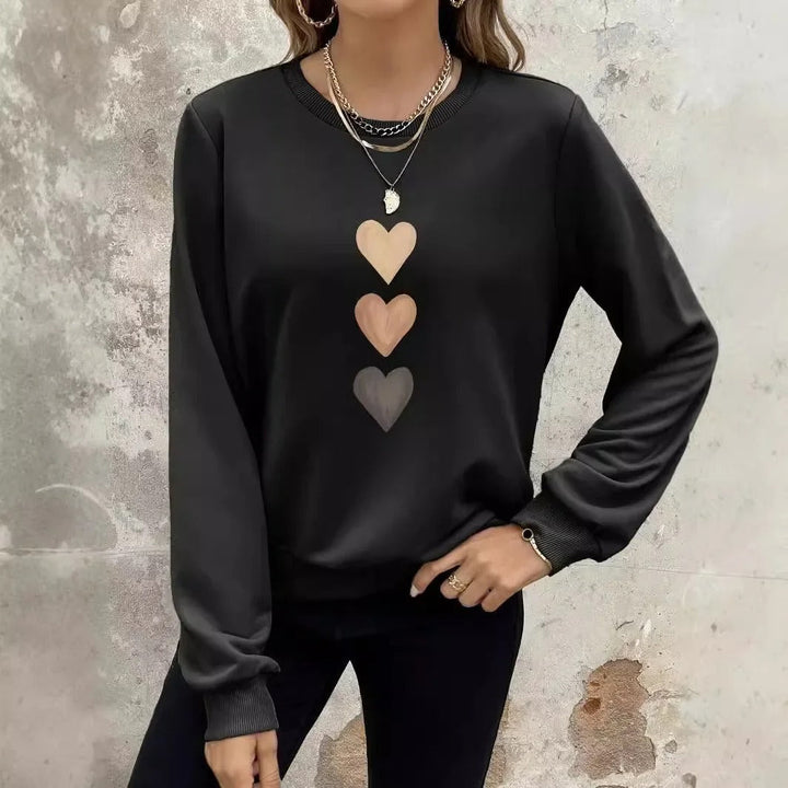 Maglione felpato donna con grafica cuore, per un abbigliamento versatile e comodo.
