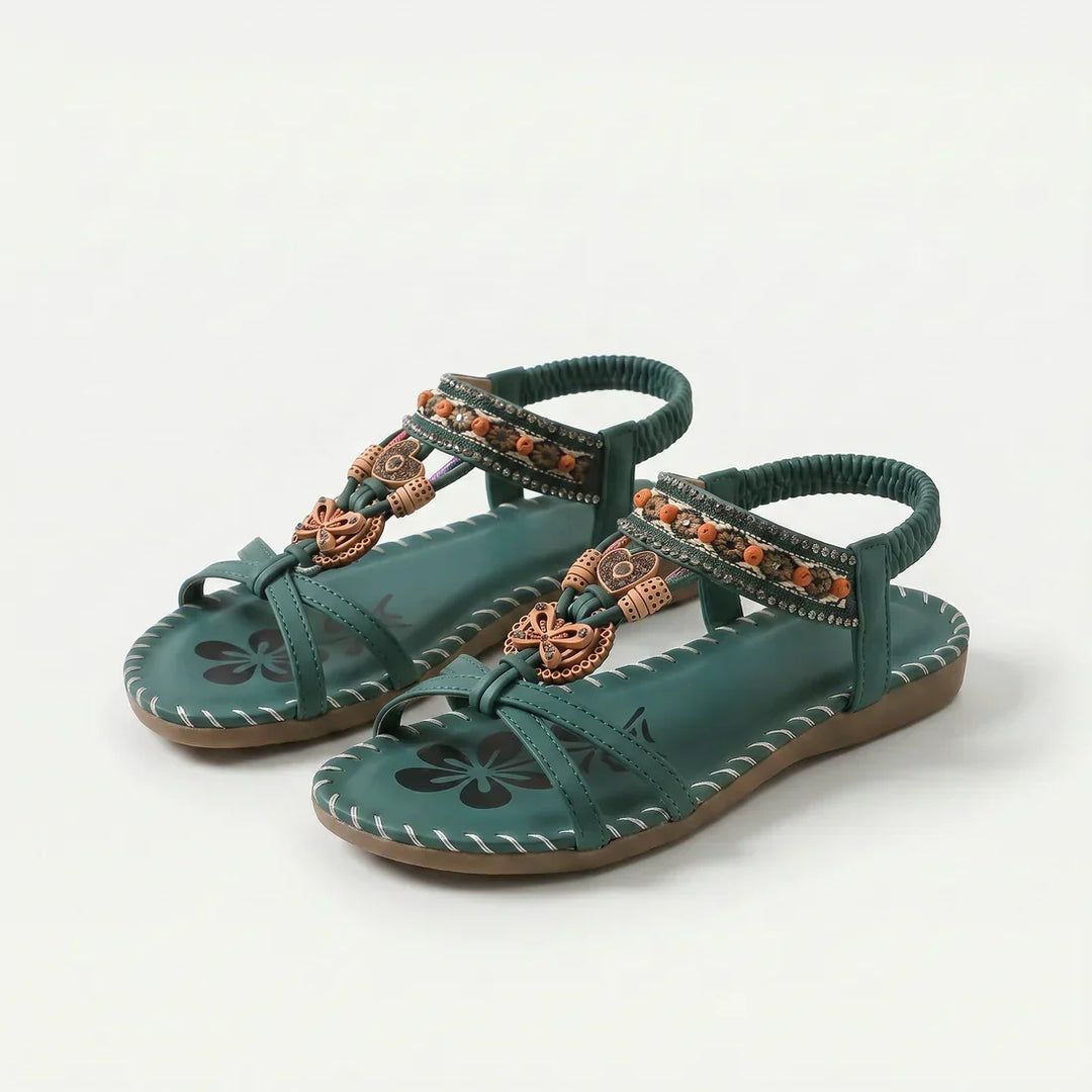 Infradito donna estive con perline delicate e design floreale sulla suola, perfette per la spiaggia.