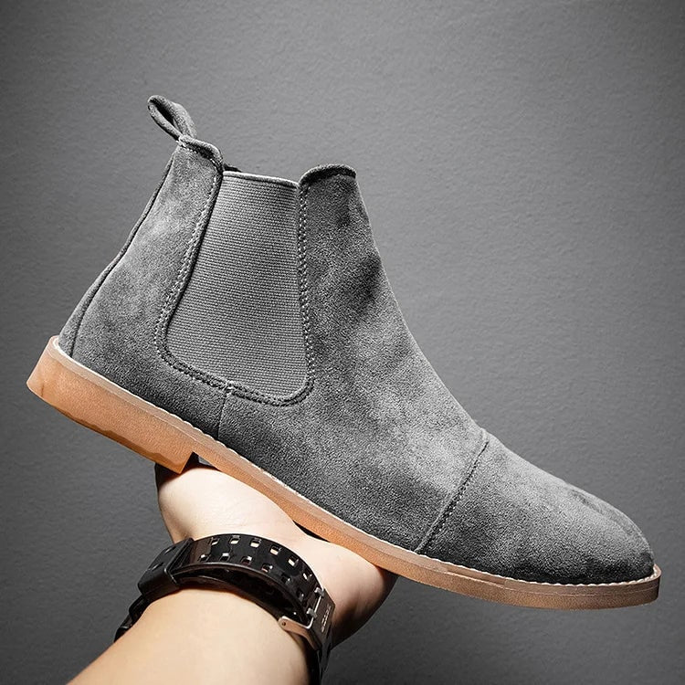 Uomo indossa stivali Chelsea neri slip-on, perfetti per look casual chic. Moda uomo con scarpe comode.