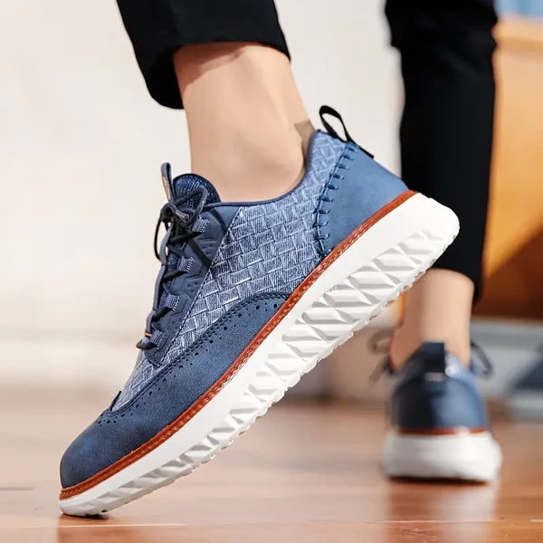 Sneakers eleganti da uomo con pannelli intrecciati e dettagli brogue. Moda maschile con stile ibrido unico.