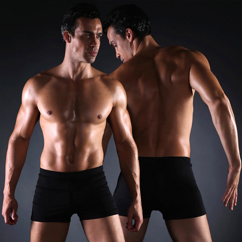 Texture tessuto tecnico pantaloncini da bagno uomo. Materiale resistente ad asciugatura rapida, ideale per il mare.