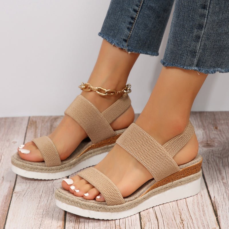 Sandali donna neri con zeppa alta e cinturino elastico. Calzature estive confortevoli e alla moda.