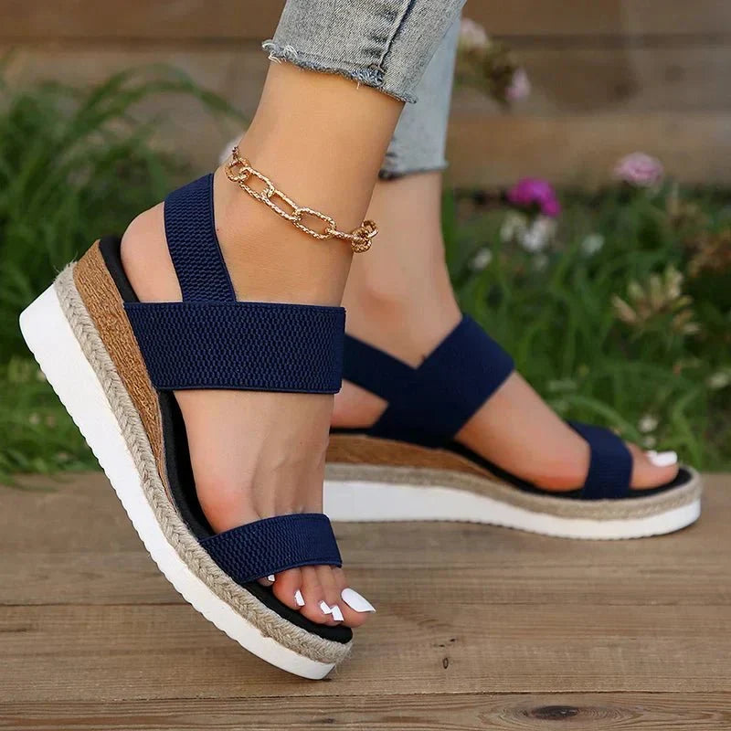 Sandali donna con zeppa alta e cinturino elastico per un comfort estivo superiore. Calzature alla moda.