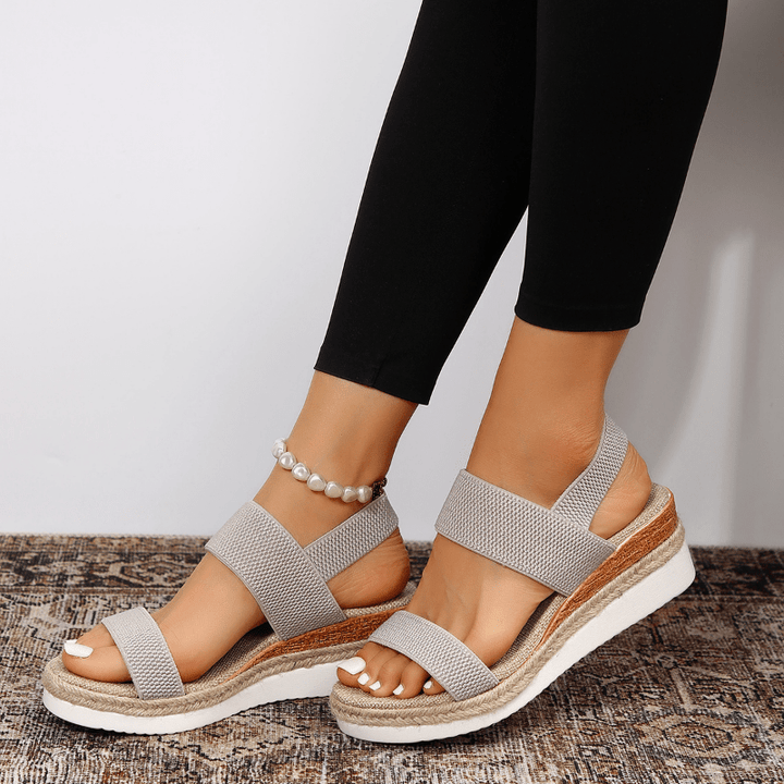 Sandali donna zeppa e cinturino elastico. Varie tonalità disponibili per un comfort e stile estivo impeccabile.